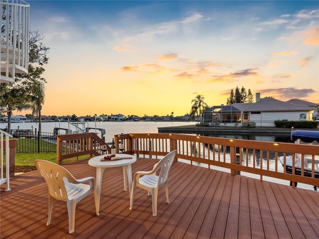 wooden terrace featuring a water view
