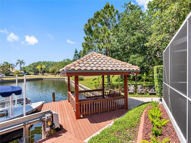 dock area with boat lift, a lanai, a water view, and a gazebo