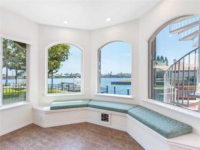 unfurnished room with a water view, baseboards, and recessed lighting