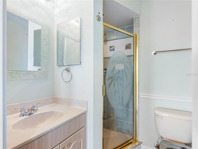 bathroom featuring a stall shower, vanity, and toilet