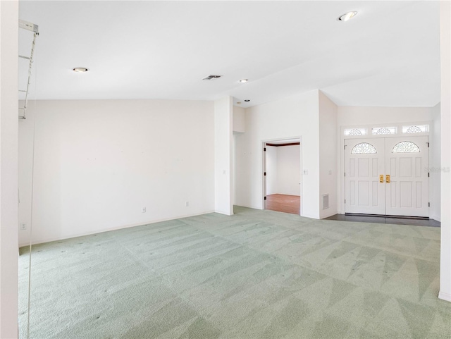 interior space featuring vaulted ceiling, visible vents, and recessed lighting