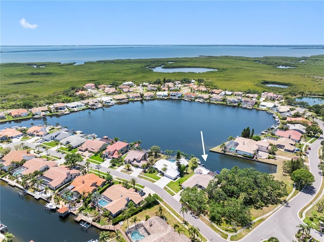 birds eye view of property with a water view and a residential view