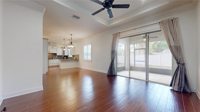3615 S Church Ave, Tampa, FL 33629 - unfurnished living room featuring a ceiling fan, a tray ceiling, ornamental molding, baseboards, and dark wood-type flooring