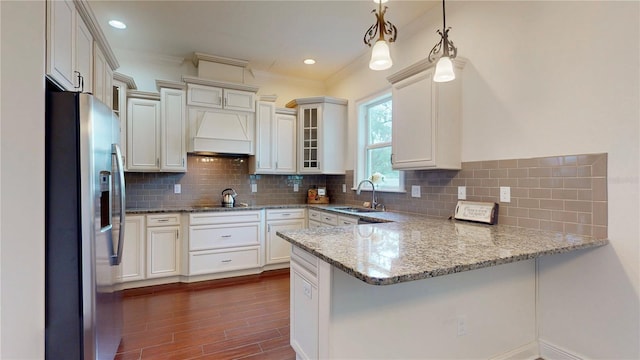 3615 S Church Ave, Tampa, FL 33629 - kitchen featuring stainless steel fridge, a sink, a peninsula, dark wood-style floors, and light stone counters