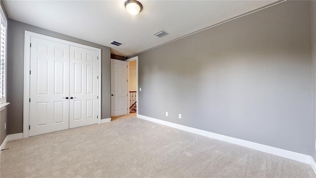 3615 S Church Ave, Tampa, FL 33629 - unfurnished bedroom featuring light carpet, baseboards, and a closet