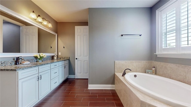 3615 S Church Ave, Tampa, FL 33629 - bathroom with a garden tub, baseboards, double vanity, and wood finished floors