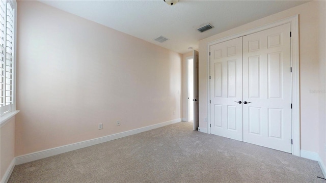 3615 S Church Ave, Tampa, FL 33629 - unfurnished bedroom with carpet, a closet, baseboards, and multiple windows