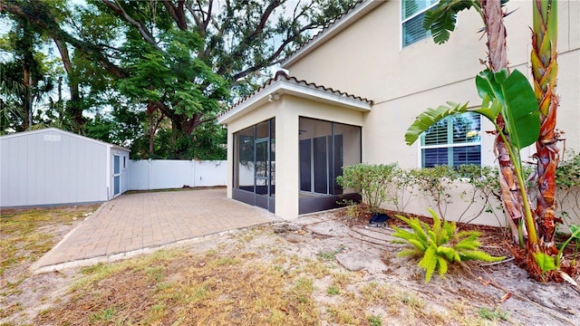 3615 S Church Ave, Tampa, FL 33629 - back of property with a sunroom, stucco siding, a fenced backyard, and an outdoor structure