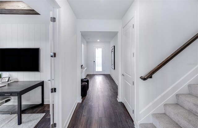 5949 Bluestar Ct, Lakewood Ranch, FL 34211 - corridor with stairs, baseboards, and dark wood-type flooring