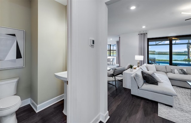 5949 Bluestar Ct, Lakewood Ranch, FL 34211 - living room featuring a water view, baseboards, dark wood finished floors, and recessed lighting