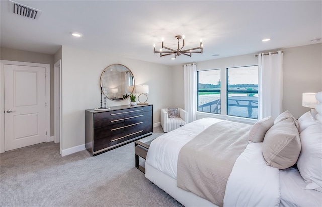 5949 Bluestar Ct, Lakewood Ranch, FL 34211 - bedroom with visible vents, an inviting chandelier, baseboards, radiator heating unit, and light colored carpet