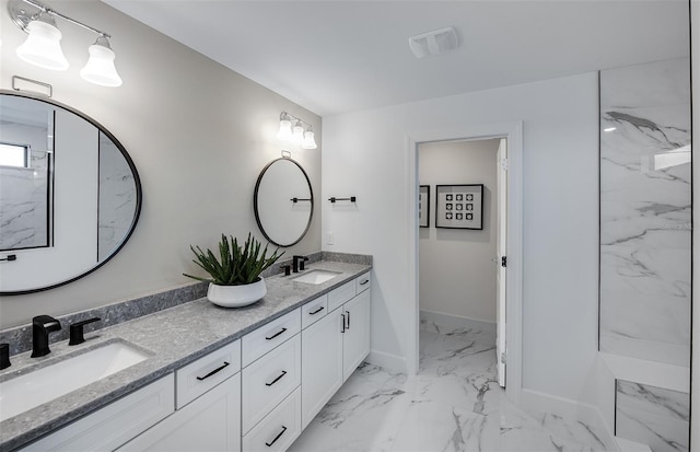 5949 Bluestar Ct, Lakewood Ranch, FL 34211 - bathroom with double vanity, visible vents, a sink, and marble finish floor