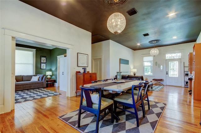 6341 Discovery Ln, Land O Lakes, FL 34638 - dining space featuring light wood-style flooring and a chandelier