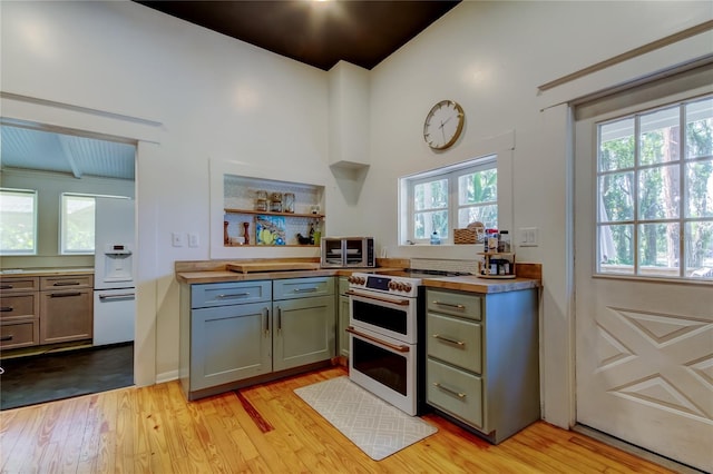 6341 Discovery Ln, Land O Lakes, FL 34638 - kitchen featuring range with two ovens, light wood-type flooring, open shelves, and vaulted ceiling