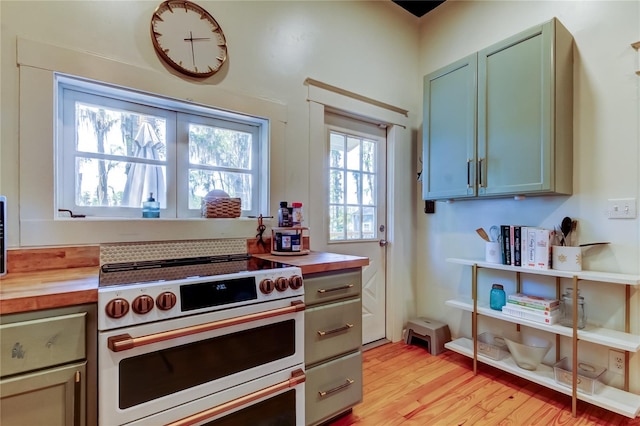 6341 Discovery Ln, Land O Lakes, FL 34638 - kitchen with double oven range, butcher block countertops, and light wood-style floors