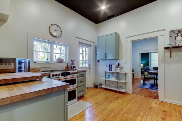 6341 Discovery Ln, Land O Lakes, FL 34638 - kitchen featuring butcher block countertops, range with two ovens, and light wood-style flooring