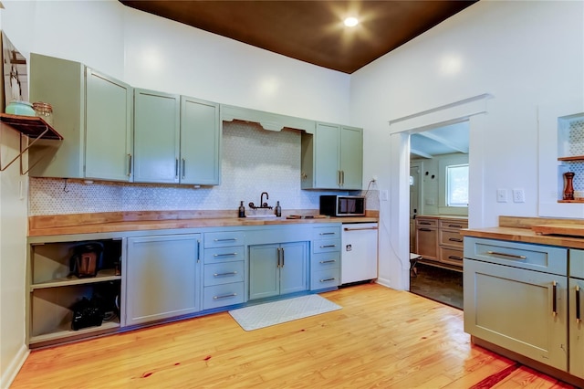6341 Discovery Ln, Land O Lakes, FL 34638 - kitchen with wooden counters, white dishwasher, stainless steel microwave, light wood-style flooring, and backsplash