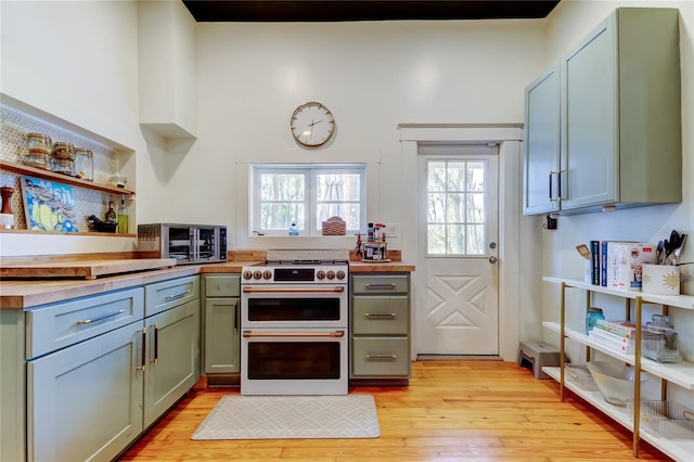 6341 Discovery Ln, Land O Lakes, FL 34638 - kitchen with double oven range, open shelves, butcher block counters, and light wood finished floors