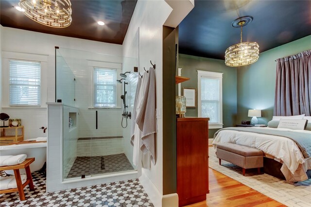 6341 Discovery Ln, Land O Lakes, FL 34638 - ensuite bathroom featuring a chandelier, a shower stall, and tile patterned floors