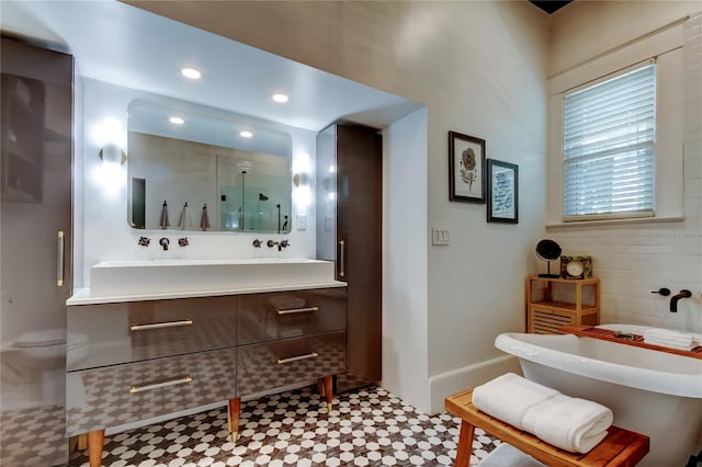 6341 Discovery Ln, Land O Lakes, FL 34638 - bathroom with vanity, a freestanding tub, an enclosed shower, baseboards, and recessed lighting