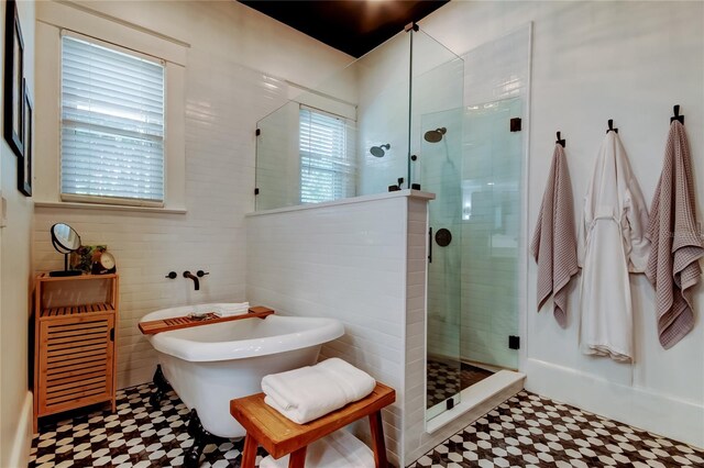 6341 Discovery Ln, Land O Lakes, FL 34638 - full bathroom with tile patterned floors, a stall shower, a freestanding bath, and tile walls