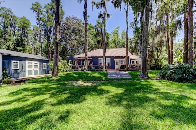 6341 Discovery Ln, Land O Lakes, FL 34638 - back of property with a yard, a deck, and view of scattered trees