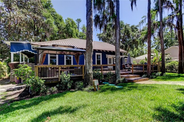 6341 Discovery Ln, Land O Lakes, FL 34638 - back of house with a deck, a lawn, and metal roof
