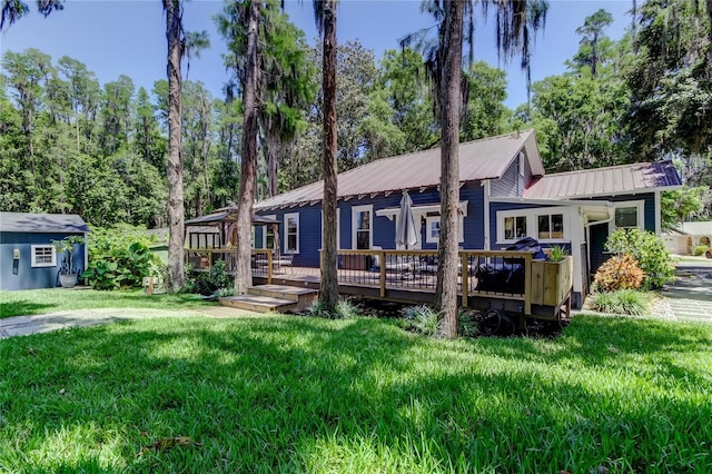 6341 Discovery Ln, Land O Lakes, FL 34638 - ranch-style house featuring a deck, a front yard, and metal roof