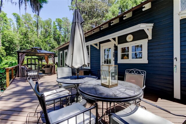 6341 Discovery Ln, Land O Lakes, FL 34638 - wooden deck featuring outdoor dining area and a gazebo