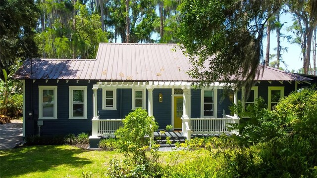 6341 Discovery Ln, Land O Lakes, FL 34638 - view of front of home with a porch, metal roof, and a front yard
