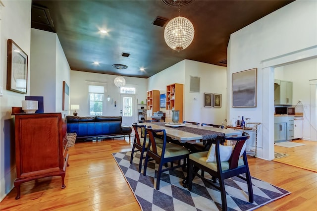 6341 Discovery Ln, Land O Lakes, FL 34638 - dining space with light wood-type flooring and a chandelier