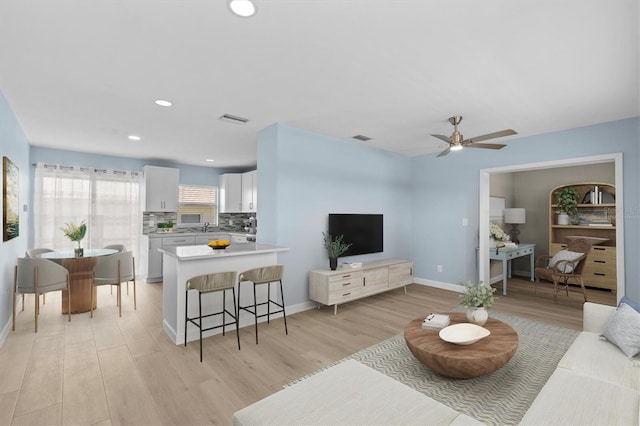 12400 Park Blvd Unit 210, Seminole, FL 33772 - living room with light wood-style floors, baseboards, and visible vents