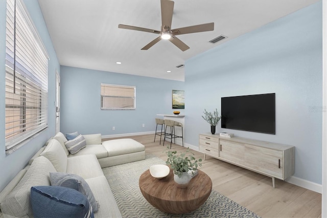 12400 Park Blvd Unit 210, Seminole, FL 33772 - living room featuring a ceiling fan, baseboards, visible vents, and wood finished floors