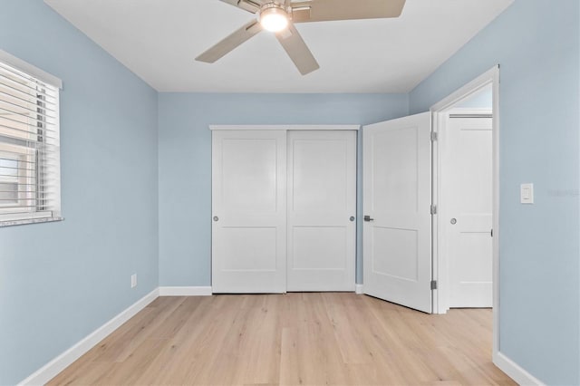 12400 Park Blvd Unit 210, Seminole, FL 33772 - unfurnished bedroom featuring baseboards, ceiling fan, light wood-style flooring, and a closet