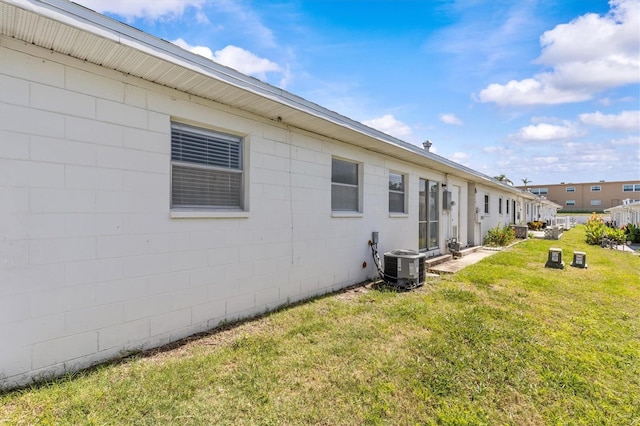 12400 Park Blvd Unit 210, Seminole, FL 33772 - view of property exterior with a yard, cooling unit, and concrete block siding