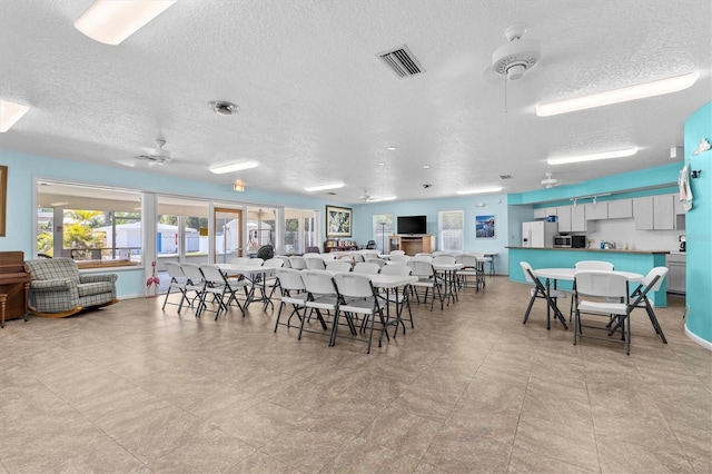 12400 Park Blvd Unit 210, Seminole, FL 33772 - dining room featuring a textured ceiling, ceiling fan, and visible vents