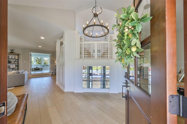 945 Bunker View Dr, Apollo Beach, FL 33572 - entrance foyer featuring recessed lighting, light wood-style flooring, a chandelier, and vaulted ceiling