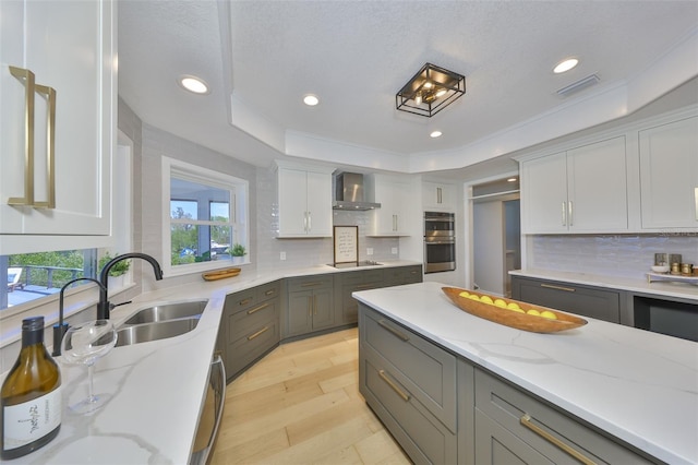 945 Bunker View Dr, Apollo Beach, FL 33572 - kitchen with wall chimney range hood, black electric stovetop, a sink, gray cabinets, and recessed lighting
