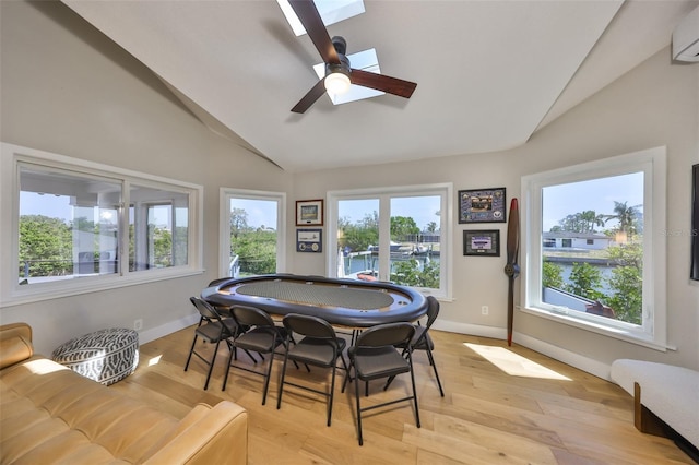 945 Bunker View Dr, Apollo Beach, FL 33572 - game room with a ceiling fan, vaulted ceiling, light wood-type flooring, a wall mounted air conditioner, and baseboards