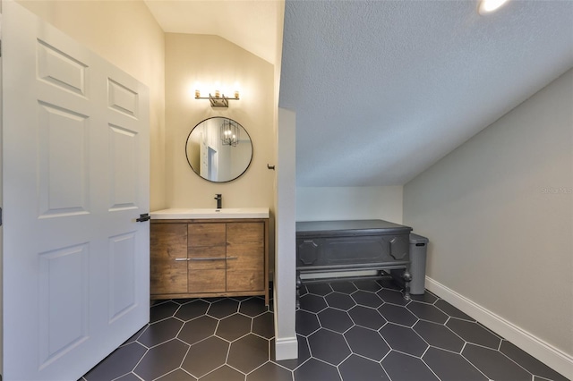 945 Bunker View Dr, Apollo Beach, FL 33572 - bathroom with vanity, tile patterned floors, baseboards, and lofted ceiling