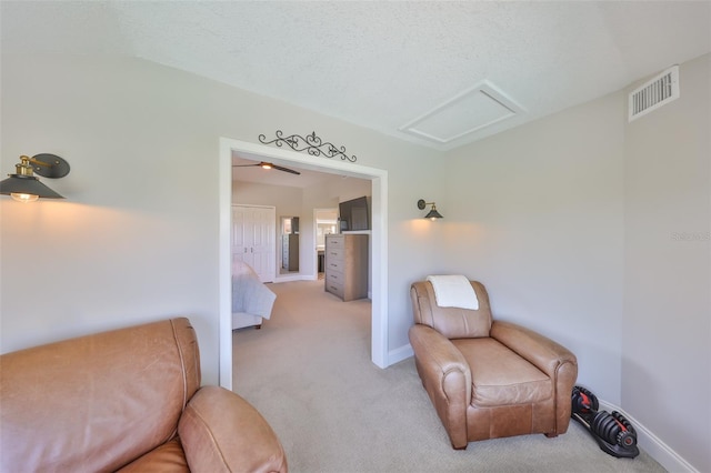 945 Bunker View Dr, Apollo Beach, FL 33572 - living area featuring light colored carpet, baseboards, visible vents, and attic access