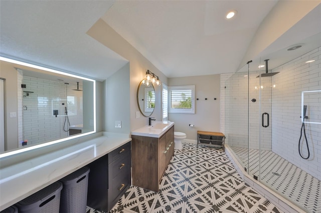 945 Bunker View Dr, Apollo Beach, FL 33572 - full bath with tile patterned flooring, vanity, toilet, lofted ceiling, and a stall shower