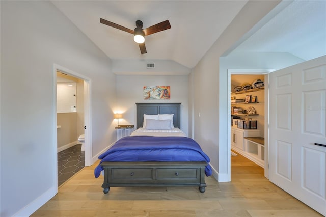 945 Bunker View Dr, Apollo Beach, FL 33572 - bedroom featuring visible vents, connected bathroom, lofted ceiling, and light wood-style floors