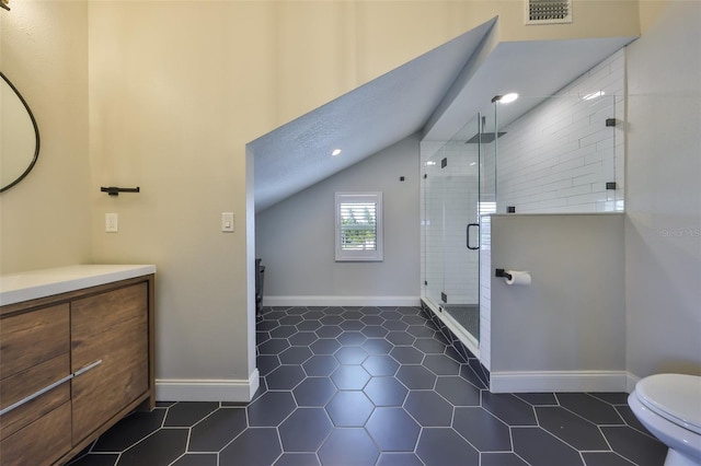 945 Bunker View Dr, Apollo Beach, FL 33572 - full bathroom with visible vents, vaulted ceiling, tile patterned floors, vanity, and toilet