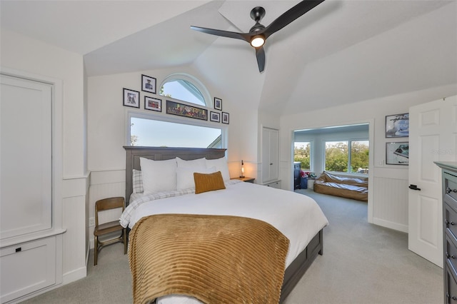 945 Bunker View Dr, Apollo Beach, FL 33572 - bedroom with light colored carpet, ceiling fan, lofted ceiling, and a wainscoted wall