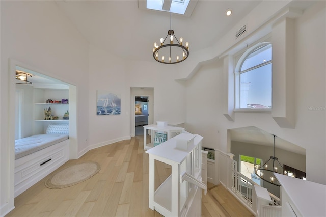 945 Bunker View Dr, Apollo Beach, FL 33572 - interior space with a high ceiling, light wood-type flooring, and a notable chandelier