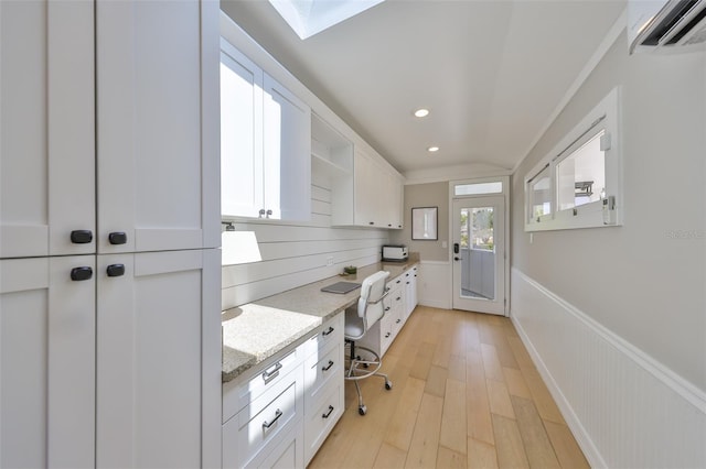945 Bunker View Dr, Apollo Beach, FL 33572 - kitchen featuring open shelves, an AC wall unit, a wainscoted wall, white cabinets, and light wood finished floors