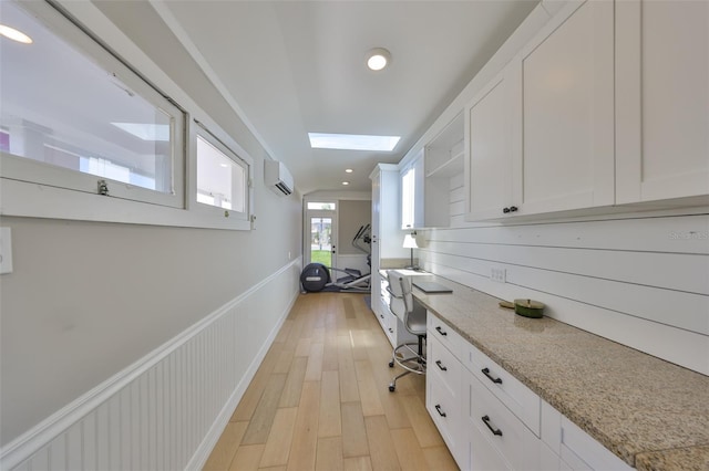 945 Bunker View Dr, Apollo Beach, FL 33572 - corridor featuring recessed lighting, a skylight, a wall unit AC, and light wood finished floors