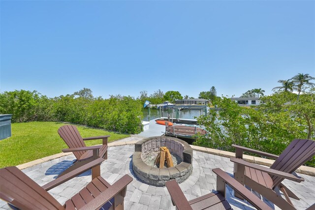 945 Bunker View Dr, Apollo Beach, FL 33572 - view of patio / terrace featuring a boat dock, an outdoor fire pit, boat lift, and a water view