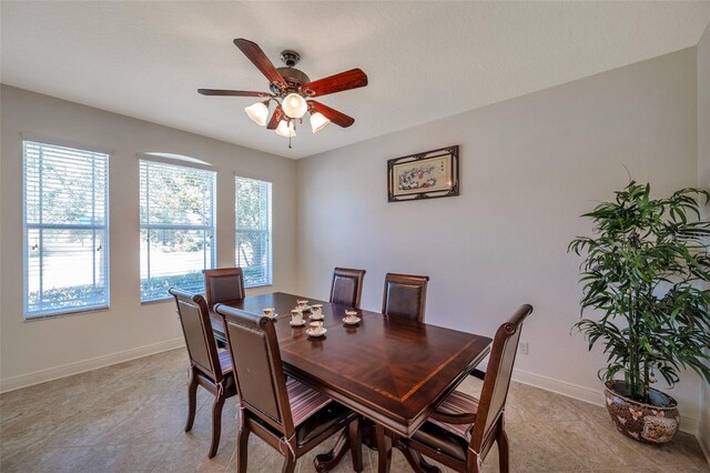 dining area with baseboards and a ceiling fan